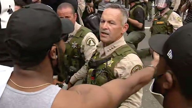 Riverside County Sheriff Chad Bianco and his deputies take a knee in support of BLM protesters